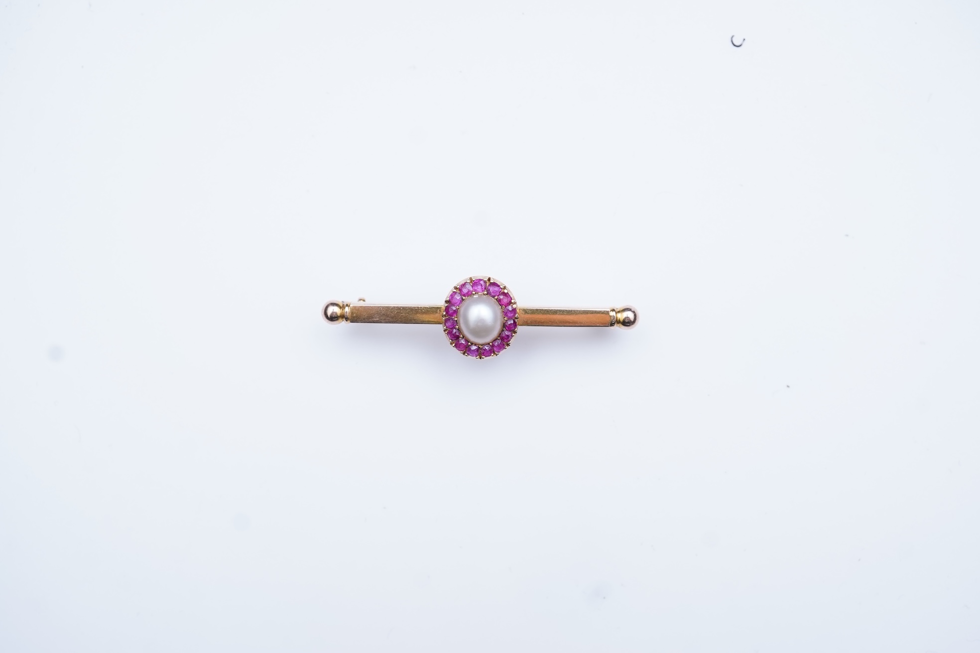 A pearl and ruby bar brooch, 19th century